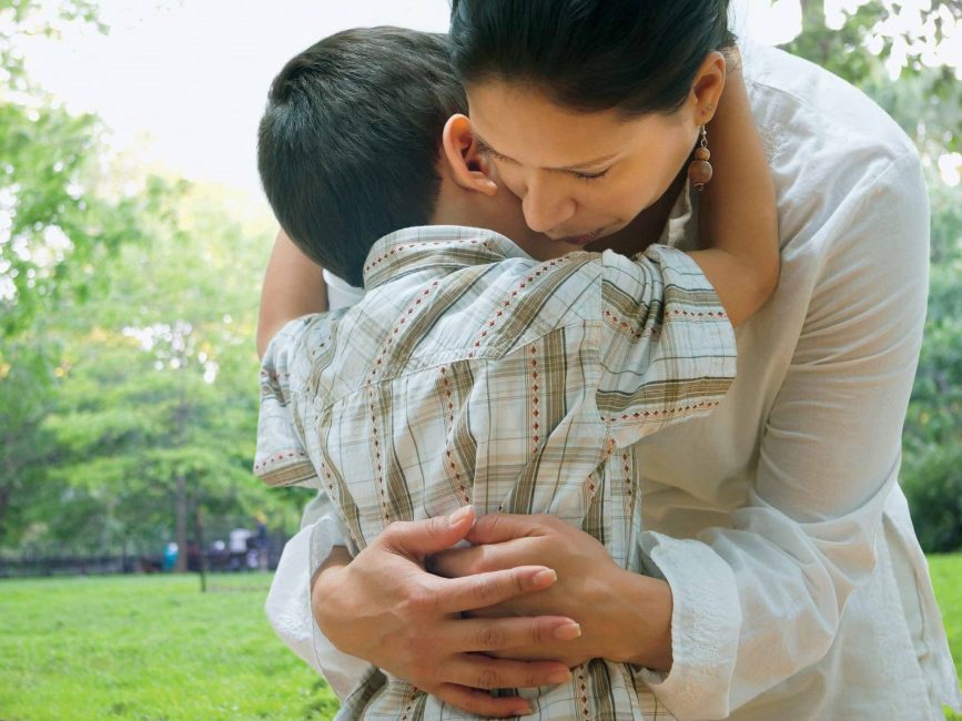 Mother and son hugging